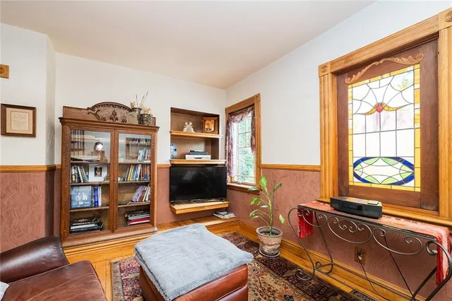 a living room with furniture a rug and a window