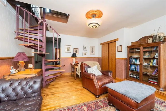 a living room with furniture fireplace and a window