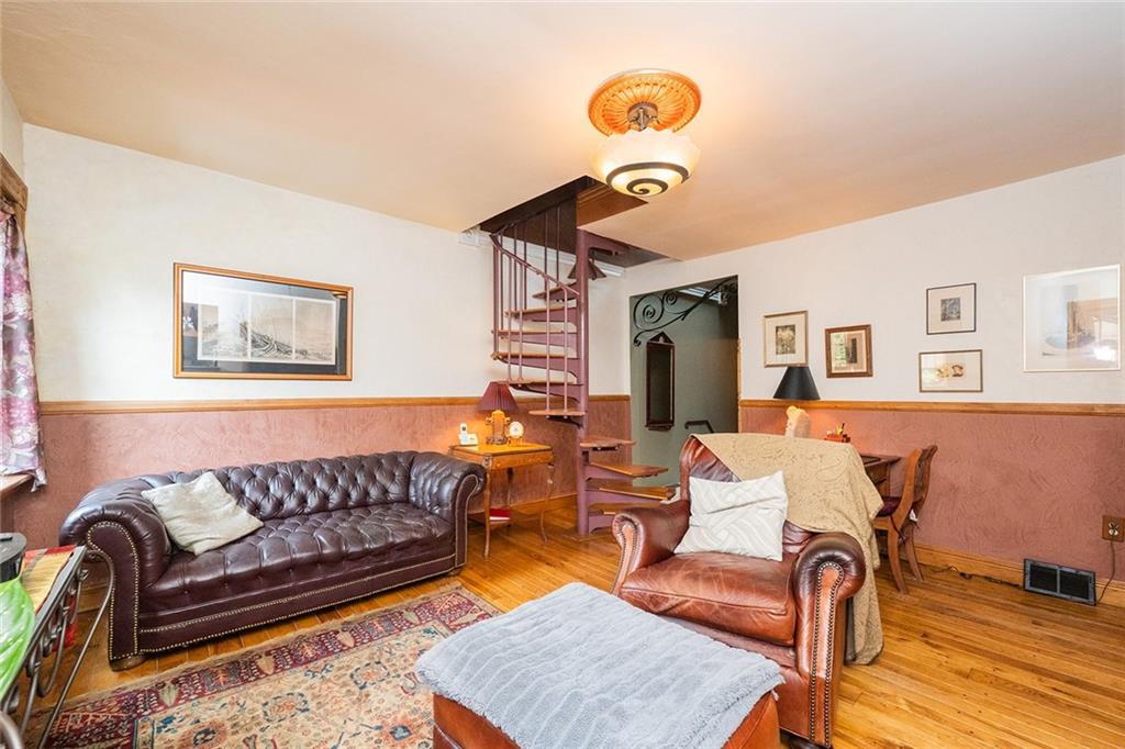 2220 Sarah Street, Unit 1 Pittsburgh, PA 15203 - Photo 17 of 37 a living room with furniture and wooden floor