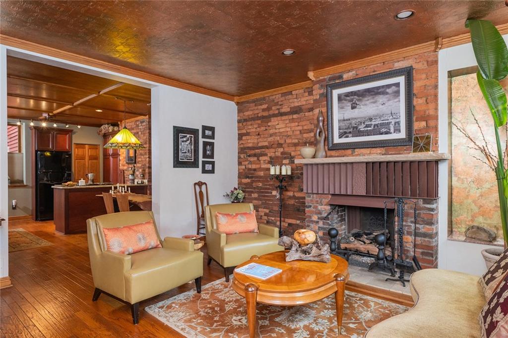 2220 Sarah Street, Unit 1 Pittsburgh, PA 15203 - Photo 2 of 37 a living room with furniture a fireplace and a large window