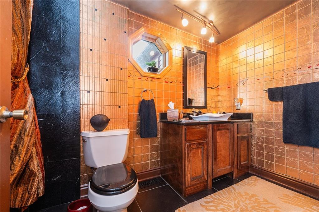 2220 Sarah Street, Unit 1 Pittsburgh, PA 15203 - Photo 21 of 37 a bathroom with a toilet a sink and a mirror