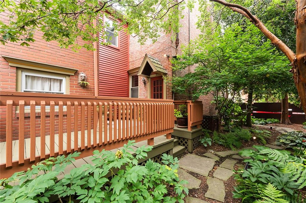 2220 Sarah Street, Unit 1 Pittsburgh, PA 15203 - Photo 26 of 37 a view of a house with a small yard and wooden fence