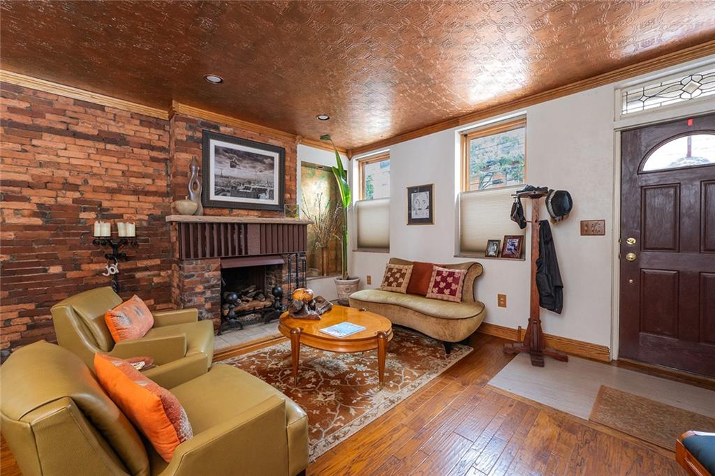 2220 Sarah Street, Unit 1 Pittsburgh, PA 15203 - Photo 3 of 37 a living room with furniture and a fireplace