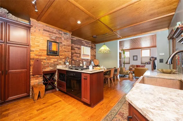 a kitchen with stainless steel appliances granite countertop sink stove and refrigerator