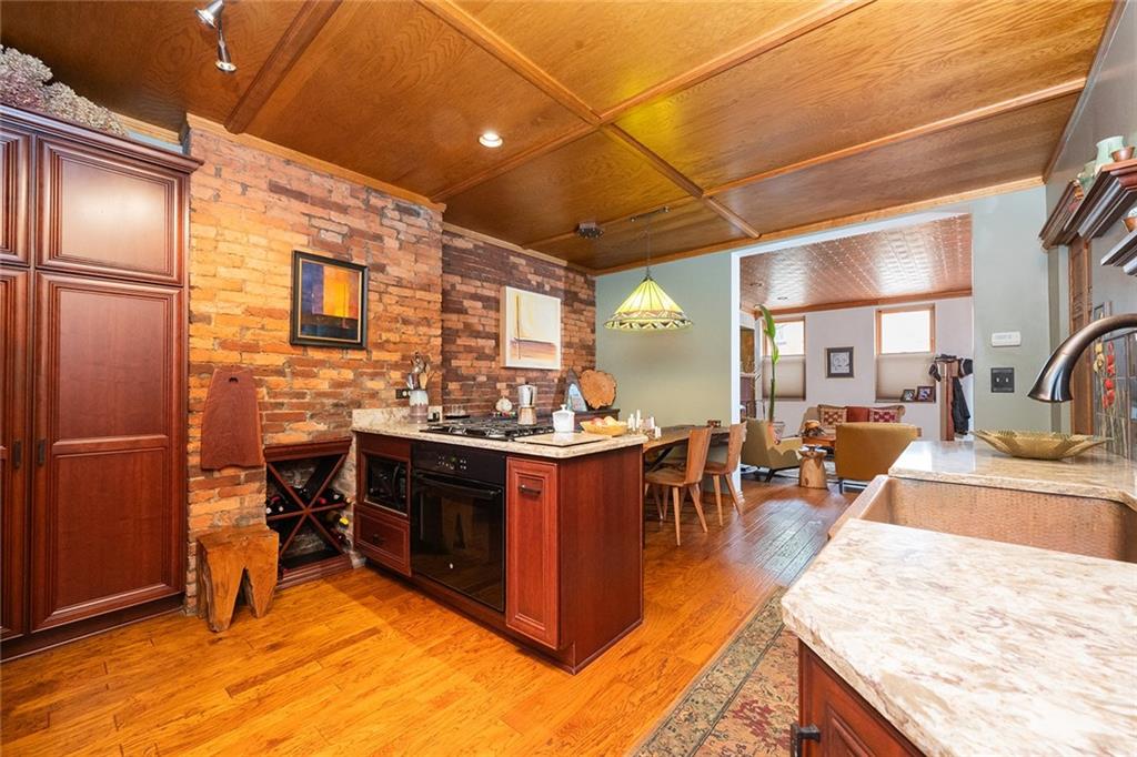2220 Sarah Street, Unit 1 Pittsburgh, PA 15203 - Photo 8 of 37 a kitchen with stainless steel appliances granite countertop sink stove and refrigerator