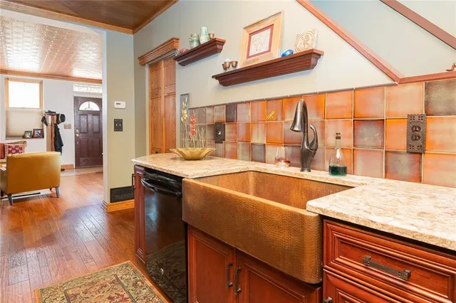 a kitchen with a sink and large windows