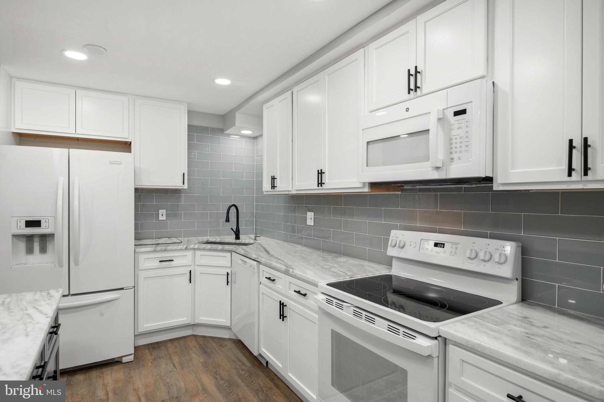 11439 Mountain View Road Damascus, MD 20872 - Photo 29 of 46 Marble counters & modern white appliances