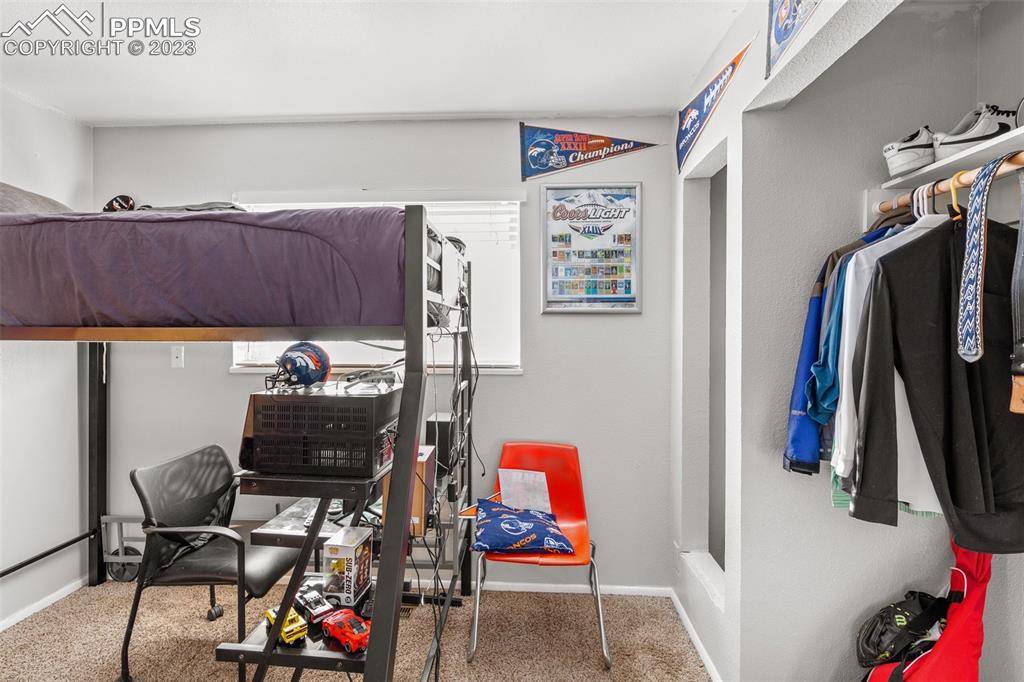 125 Chelton Road Colorado Springs, CO 80909 - Photo 13 of 26 a living room with furniture and a flat screen tv