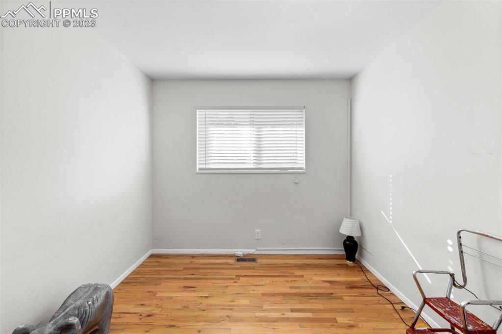 125 Chelton Road Colorado Springs, CO 80909 - Photo 14 of 26 a view of a room with wooden floor and a window