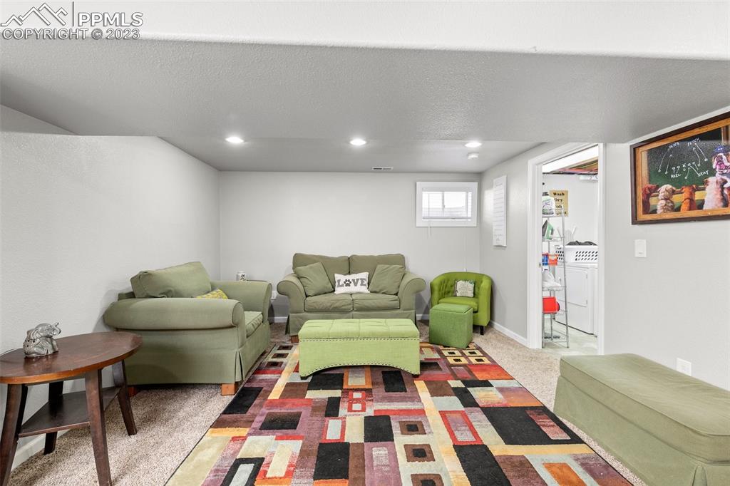 125 Chelton Road Colorado Springs, CO 80909 - Photo 15 of 26 a living room with furniture and a rug