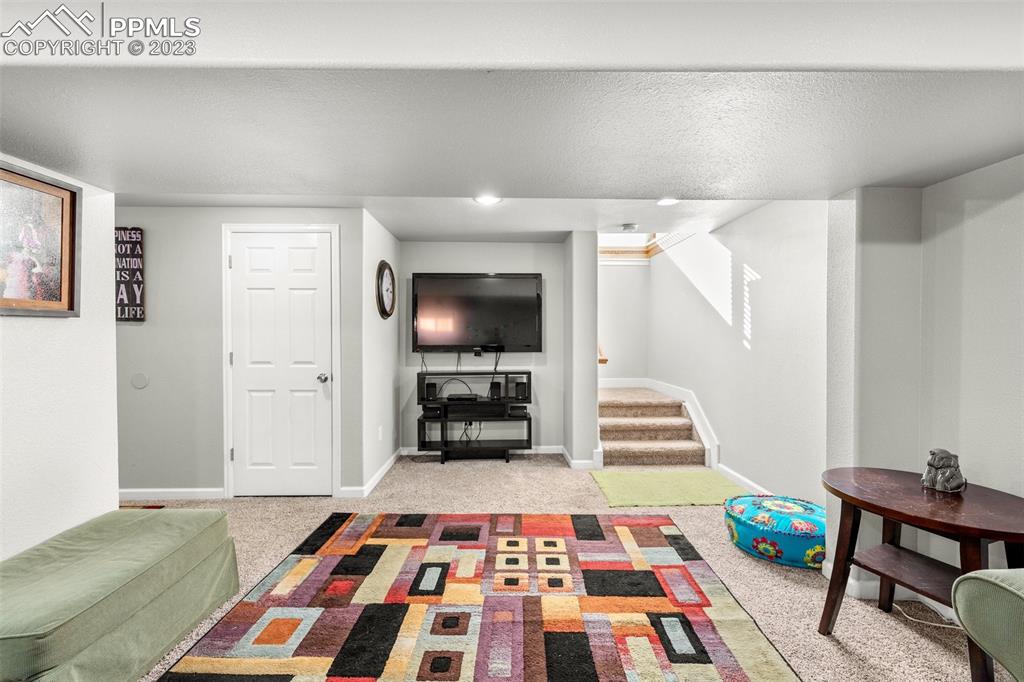 125 Chelton Road Colorado Springs, CO 80909 - Photo 16 of 26 a bedroom with furniture and a rug
