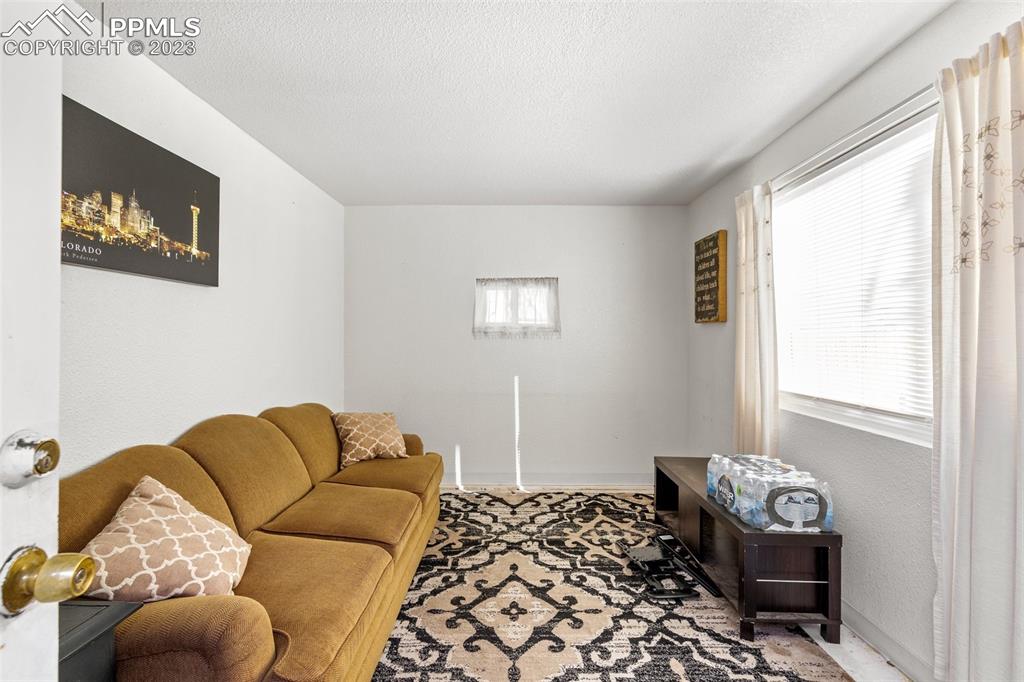 125 Chelton Road Colorado Springs, CO 80909 - Photo 21 of 26 a living room with furniture and a window