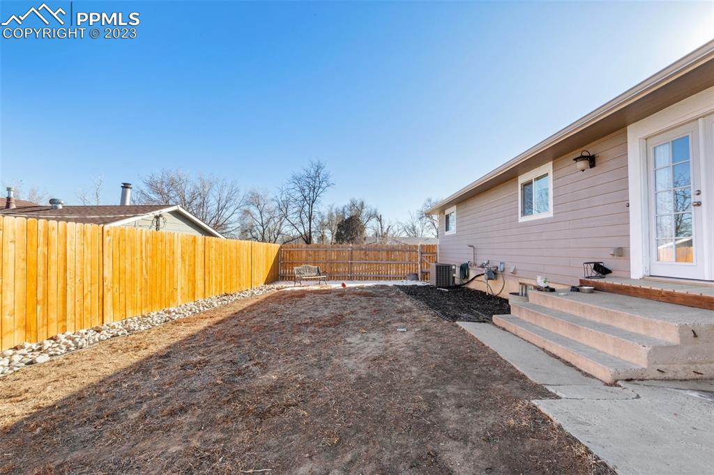 125 Chelton Road Colorado Springs, CO 80909 - Photo 23 of 26 a view of a house with backyard and sitting area