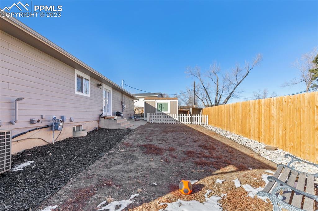 125 Chelton Road Colorado Springs, CO 80909 - Photo 24 of 26 a view of a backyard with sitting area