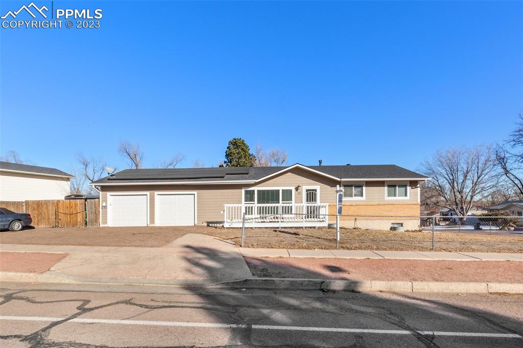 125 Chelton Road Colorado Springs, CO 80909 - Photo 26 of 26 a front view of a house with a yard