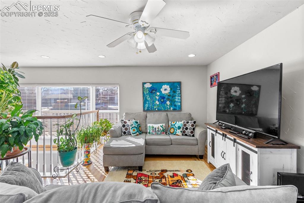 125 Chelton Road Colorado Springs, CO 80909 - Photo 3 of 26 a living room with furniture and a flat screen tv