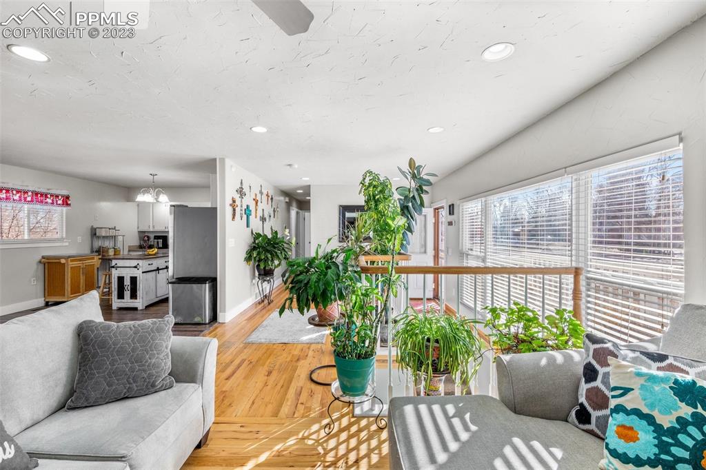 125 Chelton Road Colorado Springs, CO 80909 - Photo 4 of 26 a living room with furniture and flowers