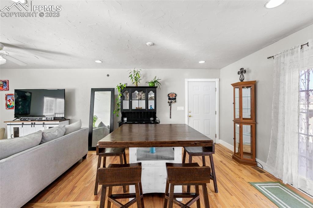 125 Chelton Road Colorado Springs, CO 80909 - Photo 5 of 26 a kitchen with stainless steel appliances granite countertop a stove a refrigerator a kitchen island a table and chairs