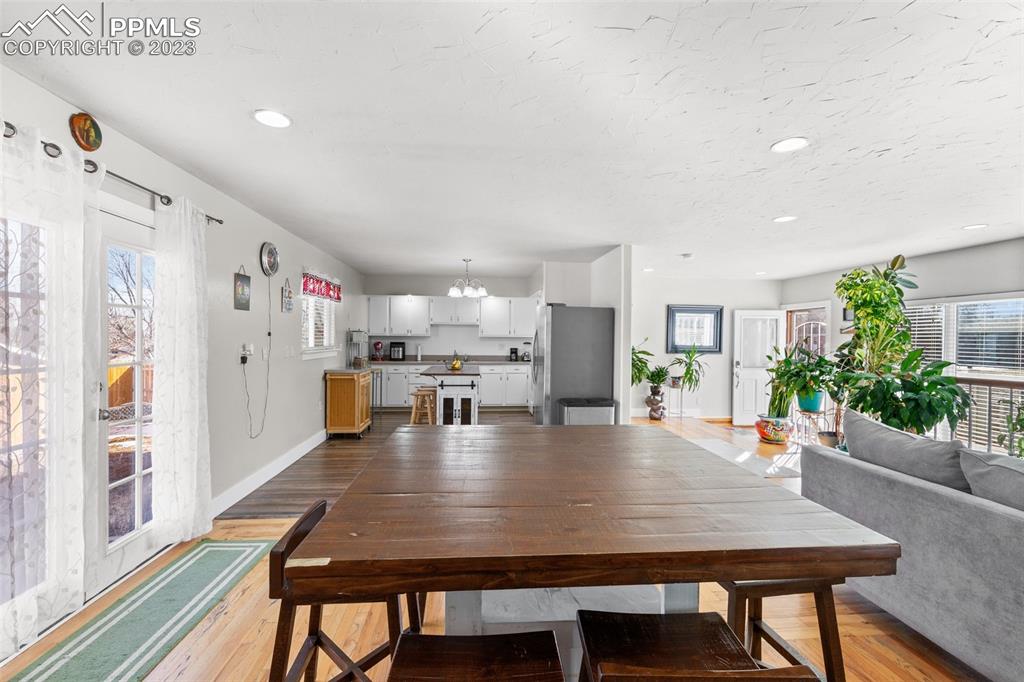 125 Chelton Road Colorado Springs, CO 80909 - Photo 7 of 26 a dining room with furniture and wooden floor