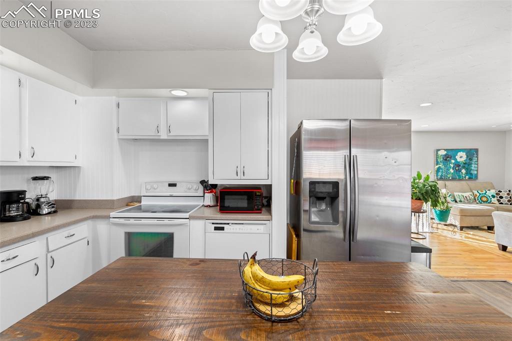 125 Chelton Road Colorado Springs, CO 80909 - Photo 9 of 26 a kitchen with cabinets and stainless steel appliances