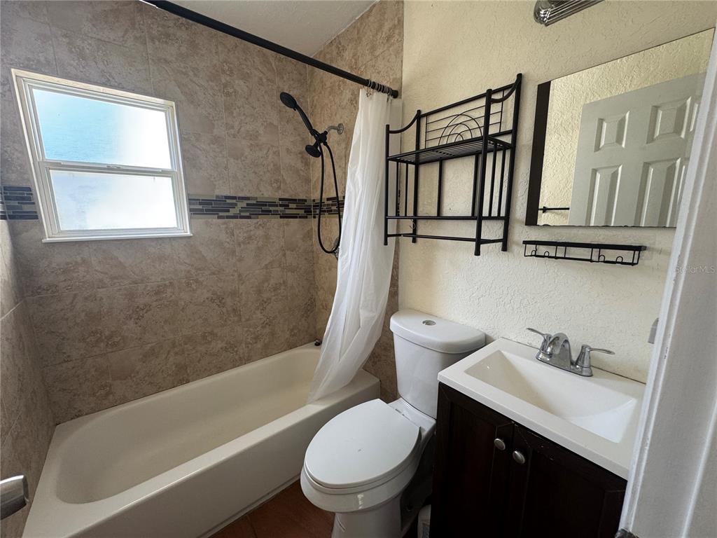 636 Columbia Street Orlando, FL 32805 - Photo 12 of 14 a bathroom with a sink toilet and shower