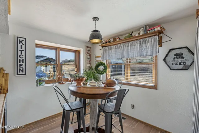 a dining room with furniture a chandelier and a window