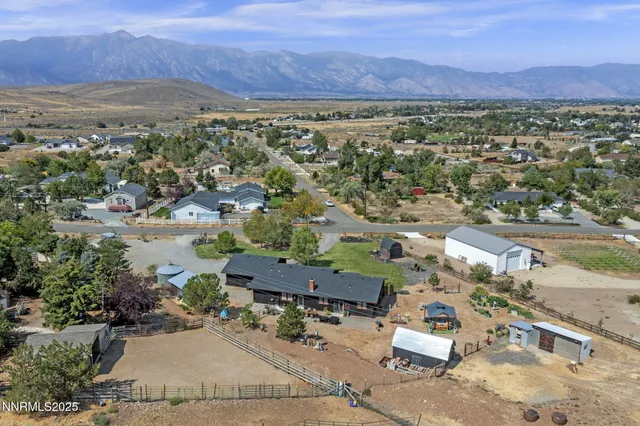 an aerial view of a house with a yard