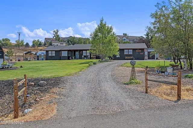 a view of a house with a yard and table