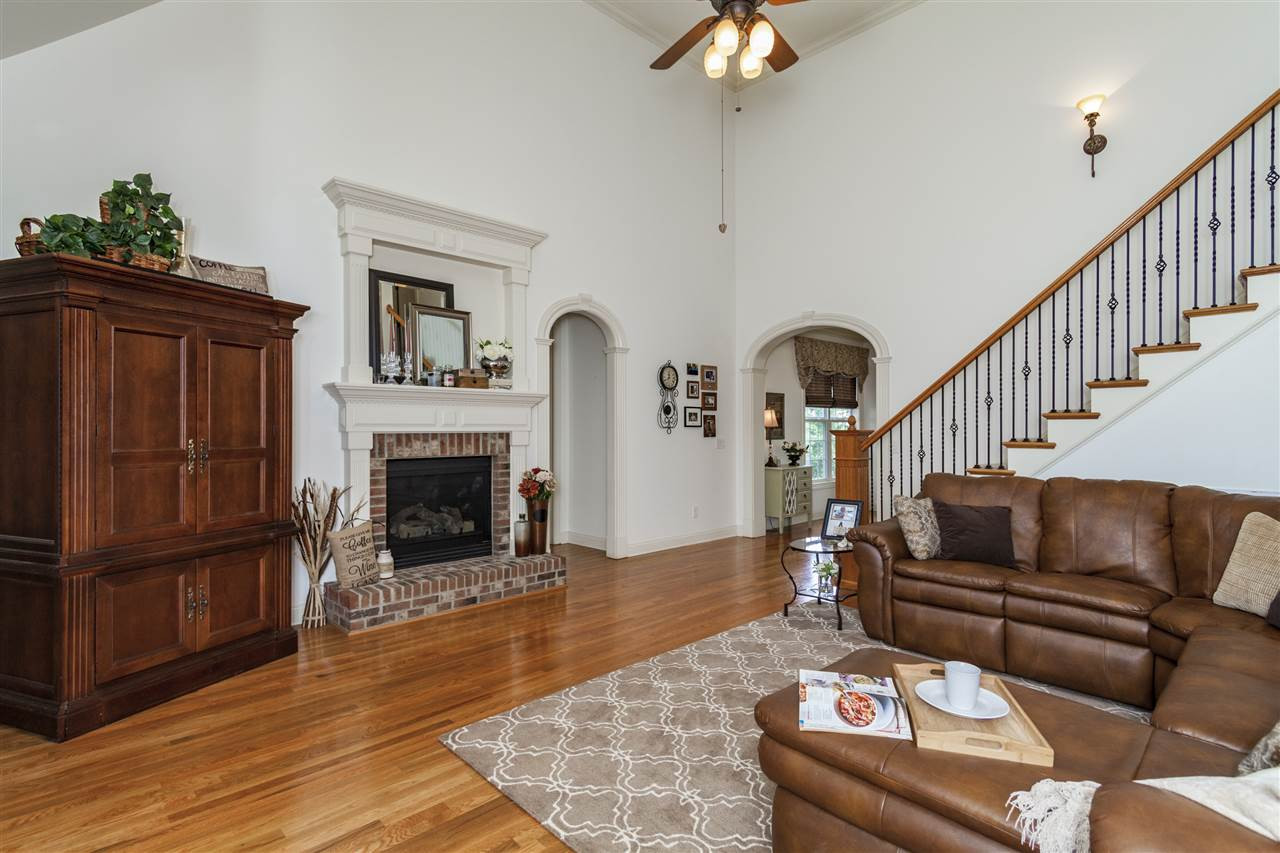 1700 Struble Circle Willow Spring, NC 27592 - Photo 9 of 25 Features vaulted two-story ceiling, ceiling fan, cut out window from kitchen, hardwood floors, Atrium windows, fireplace with custom moulding/trim, and many more appointed details. Den/Family/Great Room