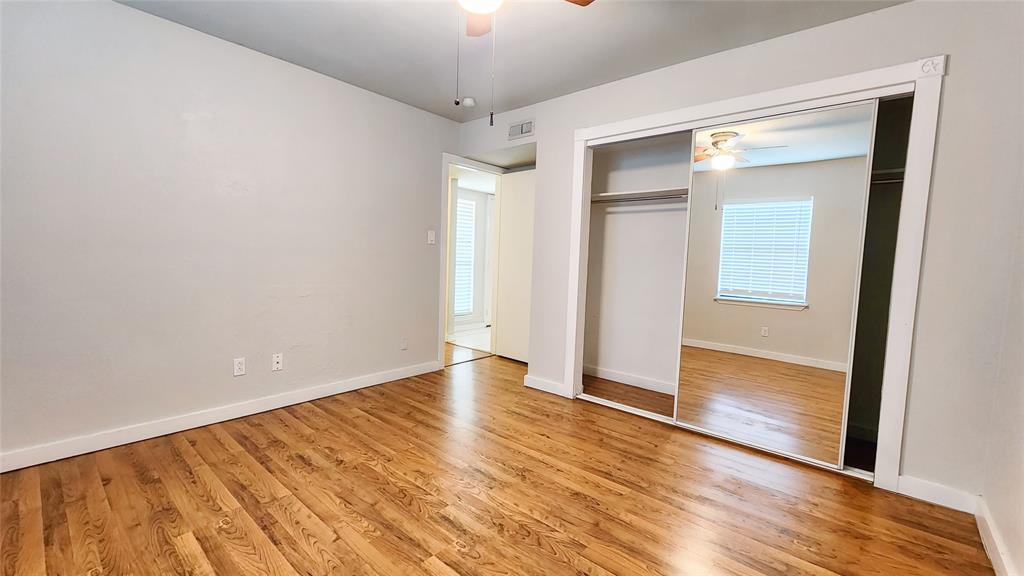 3905 Windflower Lane Fort Worth, TX 76137 - Photo 13 of 32 a view of an empty room with wooden floor and a window