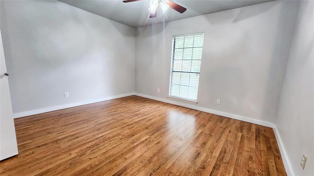 3905 Windflower Lane Fort Worth, TX 76137 - Photo 15 of 32 wooden floor in an empty room with a window