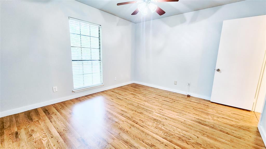 3905 Windflower Lane Fort Worth, TX 76137 - Photo 18 of 32 an empty room with wooden floor and windows