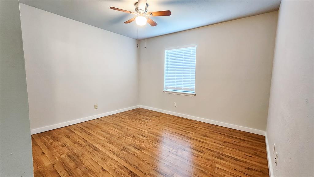 3905 Windflower Lane Fort Worth, TX 76137 - Photo 21 of 32 wooden floor in an empty room with a window