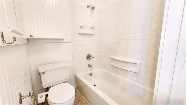 a bathroom with a bathtub and a toilet
