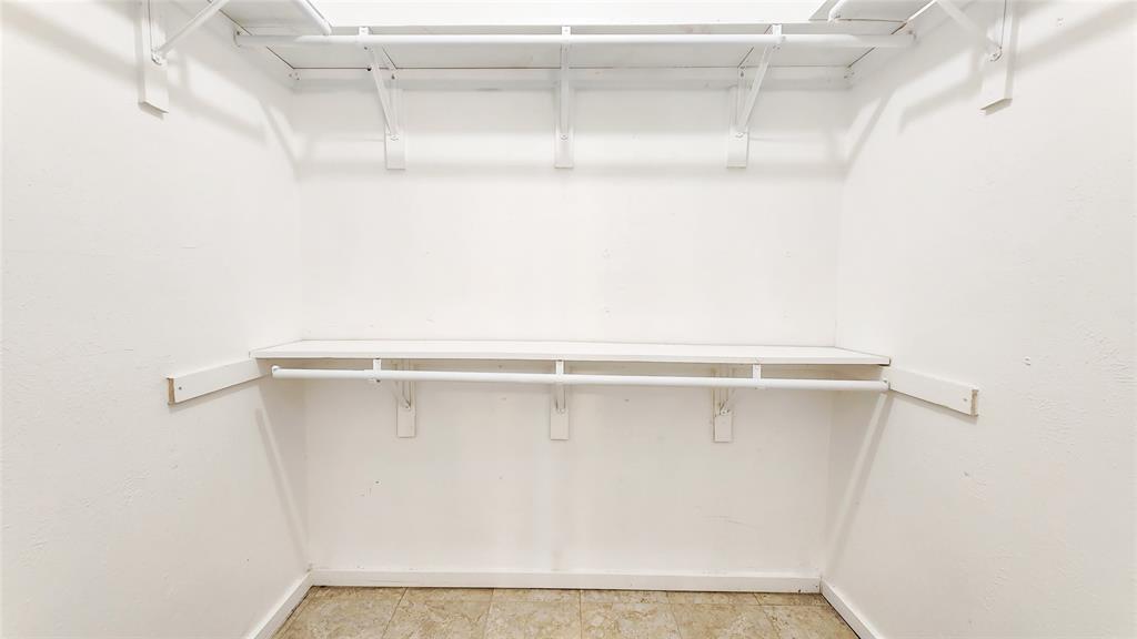 3905 Windflower Lane Fort Worth, TX 76137 - Photo 26 of 32 a view of a room with racks on the wall