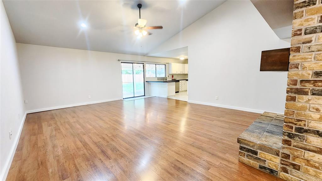 3905 Windflower Lane Fort Worth, TX 76137 - Photo 6 of 32 wooden floor in an empty room with a window