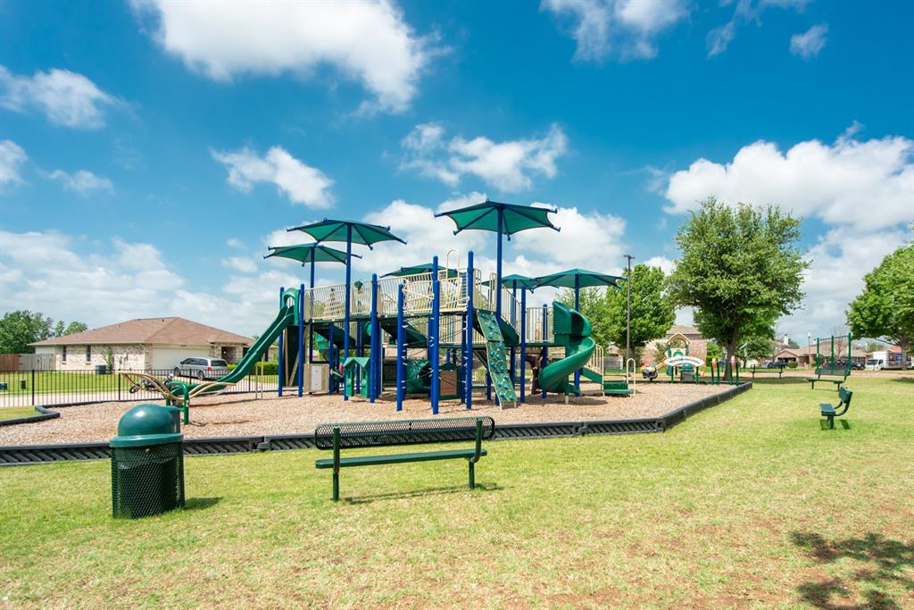 5718 Green Ivy Road Denton, TX 76210 - Photo 30 of 37 Community park featuring a multi-level play structure with slides and climbing elements, shaded by integrated canopies
