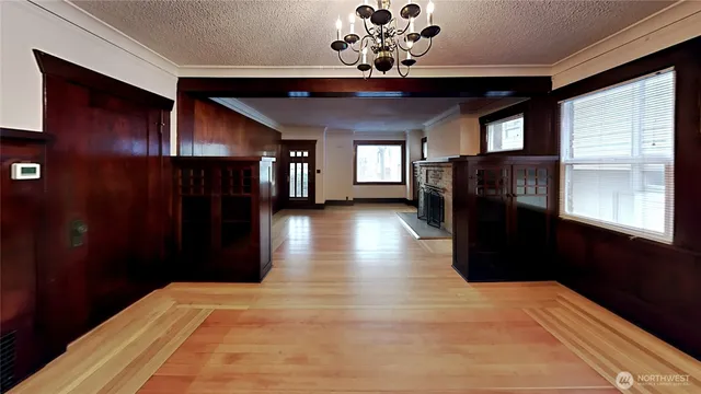 a view of a room with wooden floor and windows