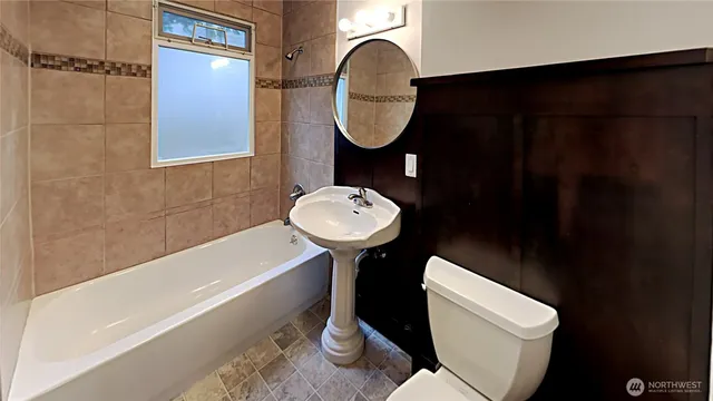 a bathroom with a toilet a sink and a bathtub