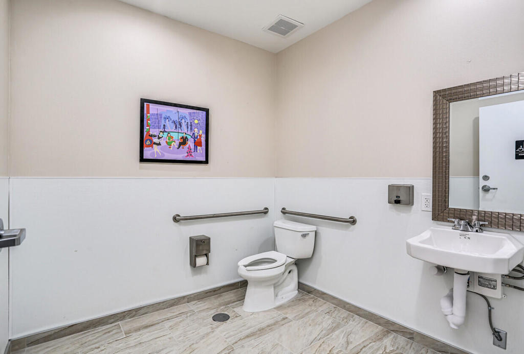 750 East Tahquitz Canyon Way, Unit 5 Palm Springs, CA 92262 - Photo 12 of 19 a bathroom with a toilet a sink and a mirror