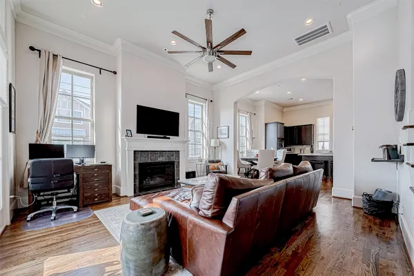 a living room with furniture a fireplace and a flat screen tv