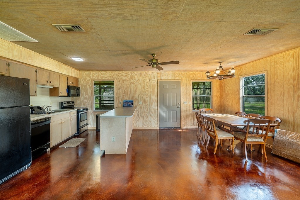 1561 Cr 154 Road Weimar, TX 78962 - Photo 9 of 46 a kitchen with a table chairs refrigerator and microwave