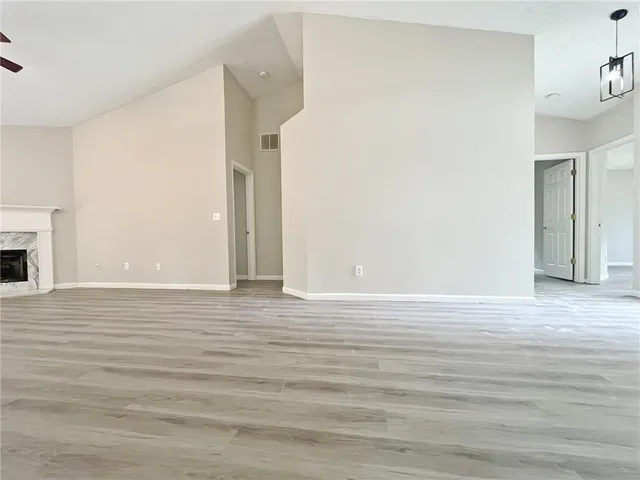 a view of a room with wooden floor