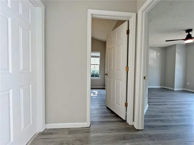 a view of a hallway with wooden floor