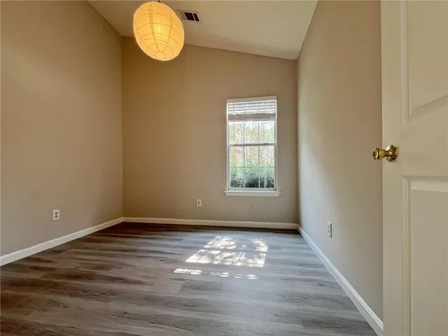 a view of room with window and wooden floor