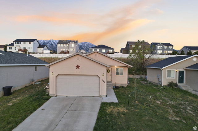 1662 East Ridgefield Road Spanish Fork, UT 84660 - Photo 1 of 18 Contemporary single-story residence featuring an attached garage with a concrete driveway and walkway