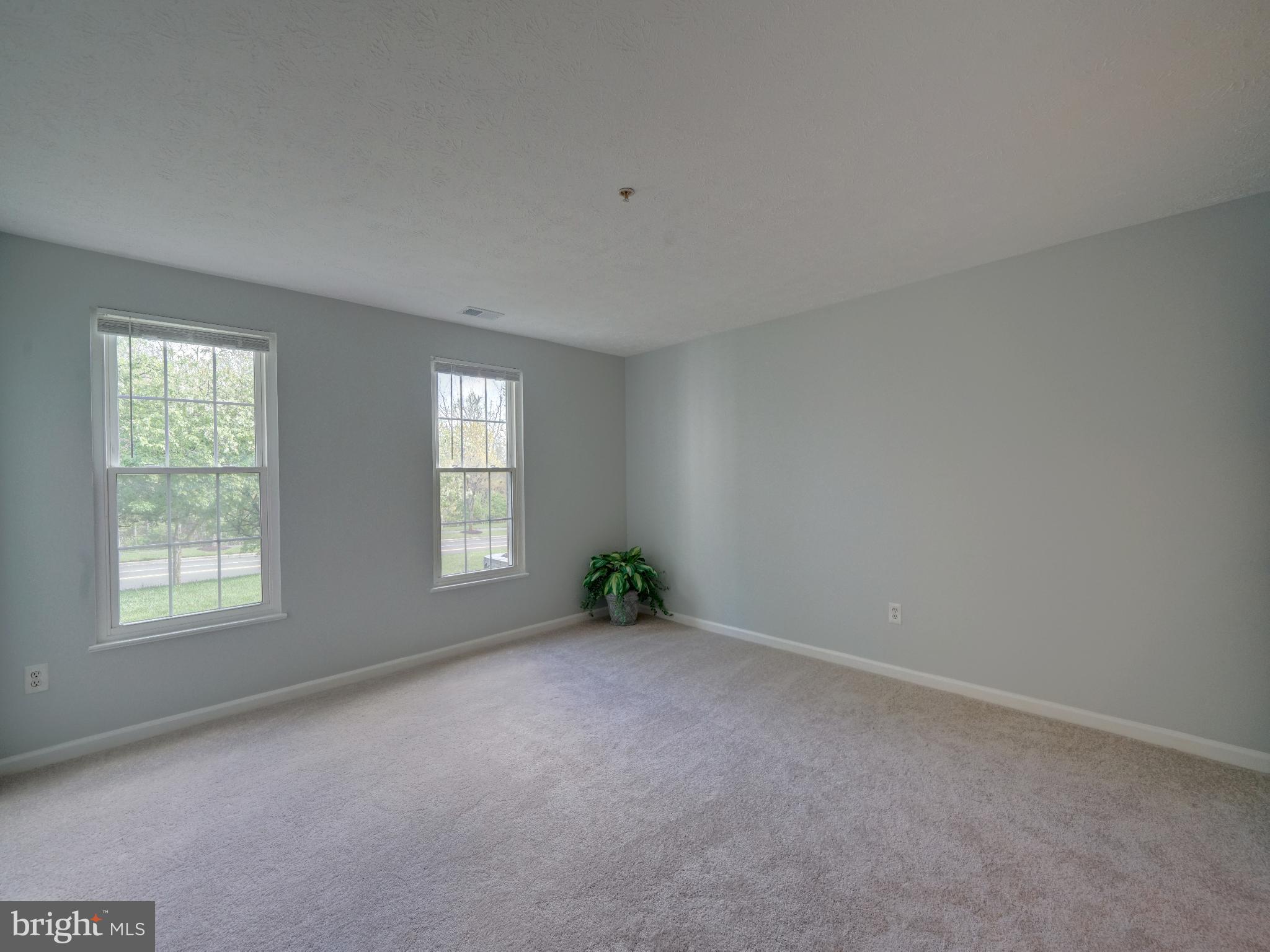 693 Winding Stream Way, Unit 103 Odenton, MD 21113 - Photo 11 of 26 an empty room with windows