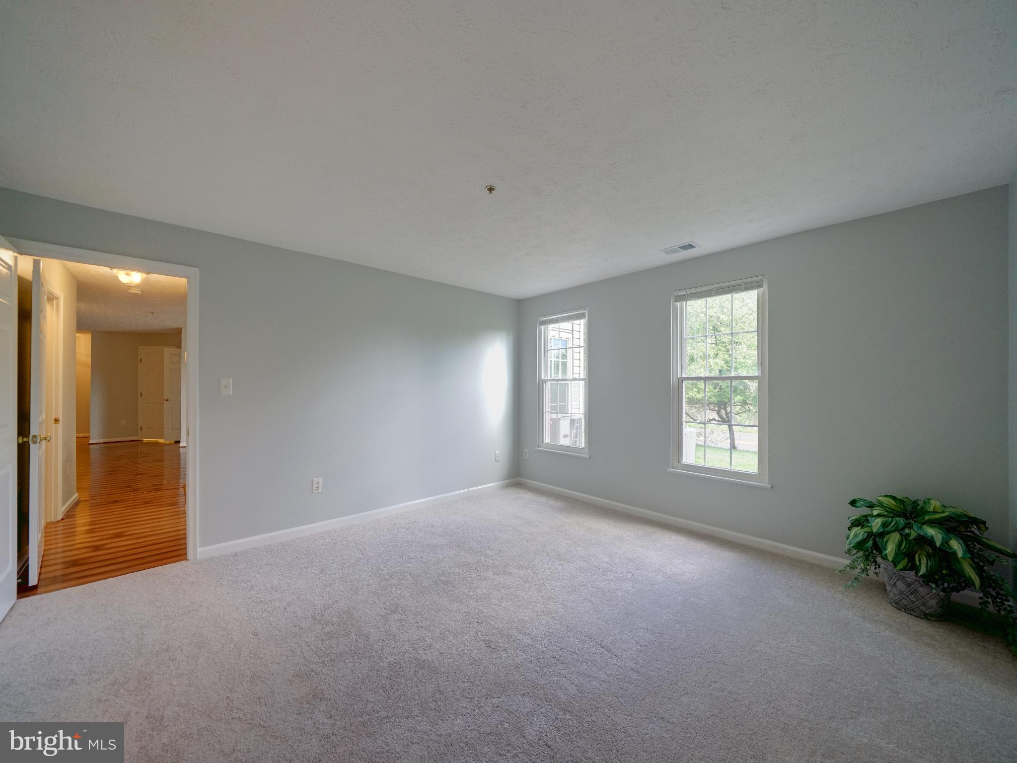 693 Winding Stream Way, Unit 103 Odenton, MD 21113 - Photo 13 of 26 a view of an empty room with a window