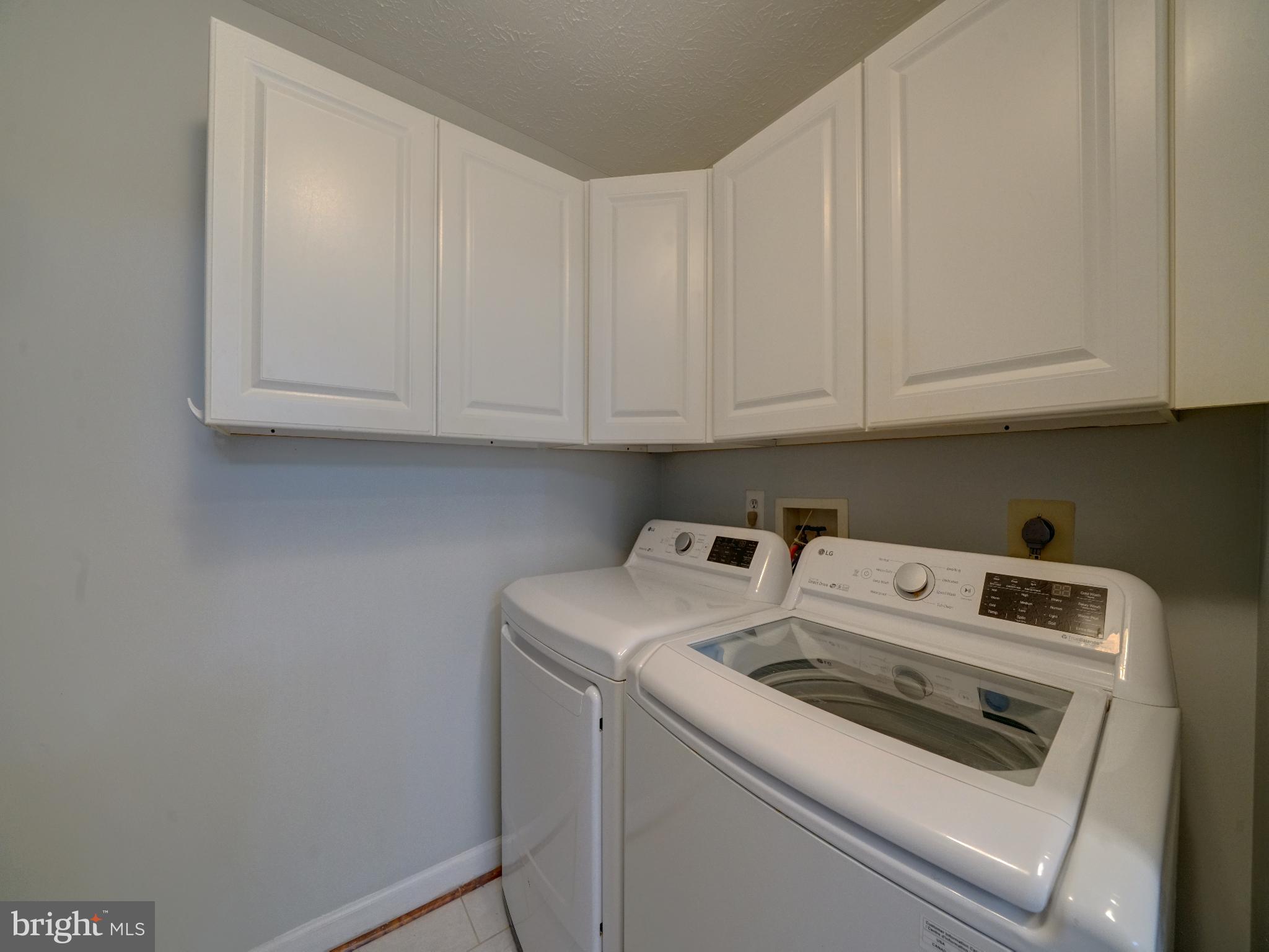 693 Winding Stream Way, Unit 103 Odenton, MD 21113 - Photo 17 of 26 a view of washer and dryer with kitchen countertops