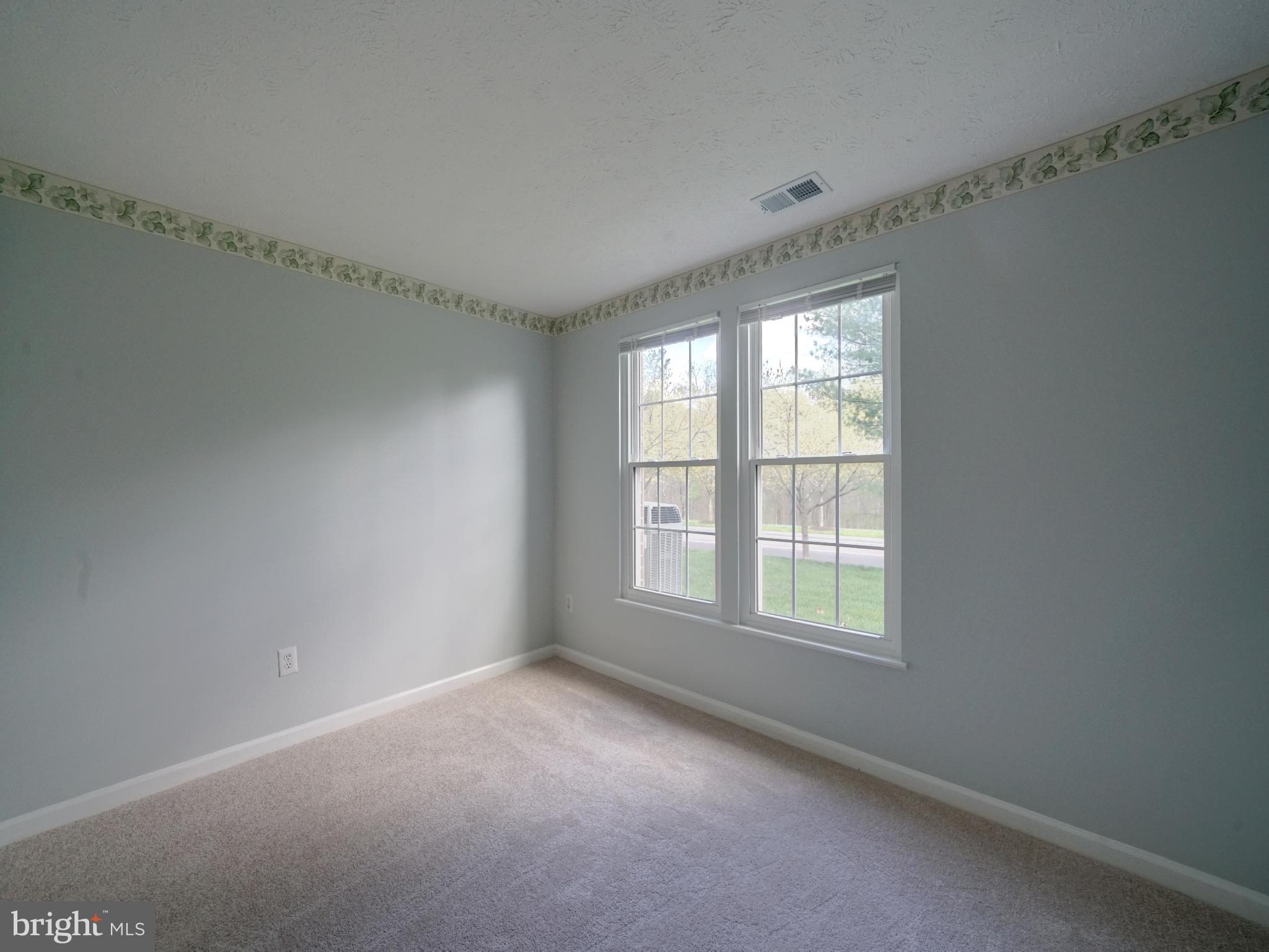 693 Winding Stream Way, Unit 103 Odenton, MD 21113 - Photo 18 of 26 a view of an empty room with a window